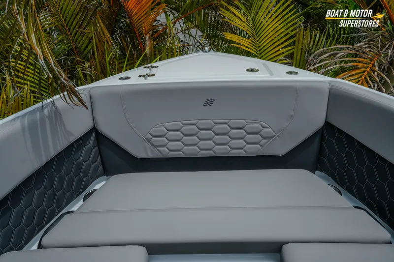 Slide: The Image of 2026 Four Winns H9 OB boat interior with gray cushioned seating and hexagonal pattern design. - 13