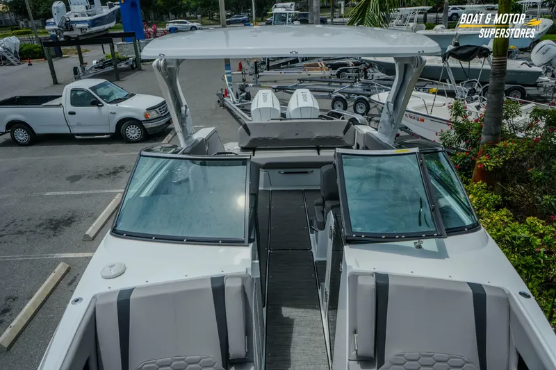 Slide: The Image of 2026 Four Winns H9 OB boat with sleek design, parked in a marina setting. - 17