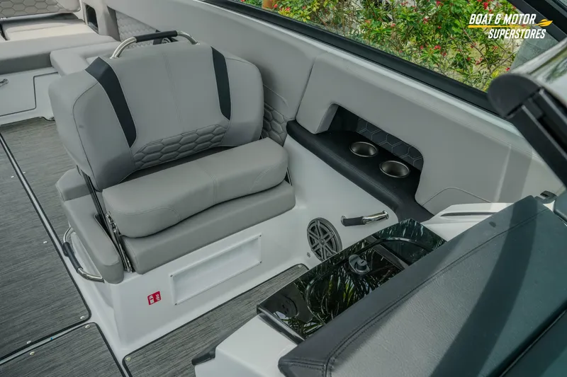 Slide: The Image of 2026 Four Winns H9 OB boat interior with gray seating and cup holders. - 22