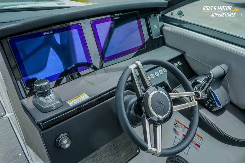 Slide: The Image of 2026 Four Winns H9 OB boat dashboard with dual Simrad displays and modern steering wheel. - 28