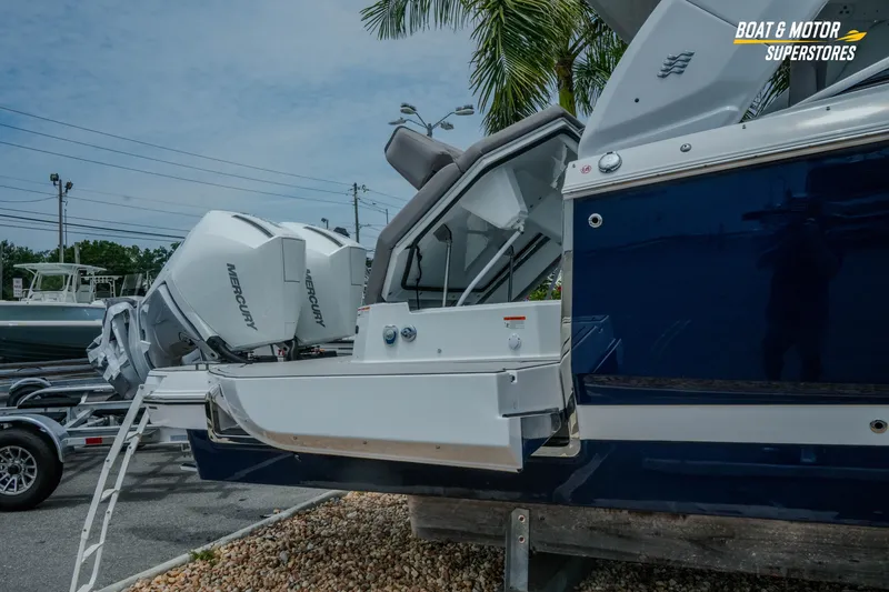 Slide: The Image of 2026 Four Winns H9 OB boat with Mercury outboard engines, displayed outdoors. - 3