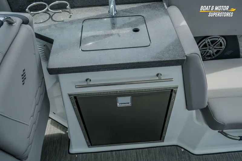 Slide: The Image of 2026 Four Winns H9 OB boat interior with sink, countertop, and storage. - 31