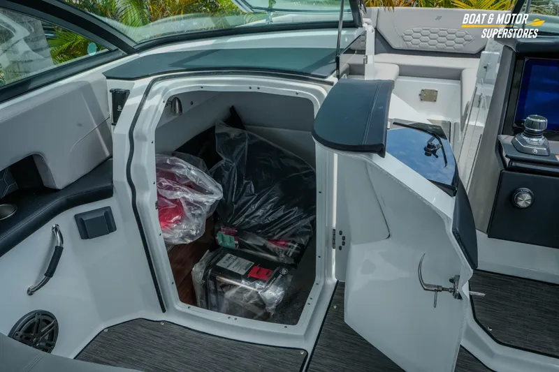 Slide: The Image of Interior storage compartment of 2026 Four Winns H9 OB boat, featuring organized equipment. - 34