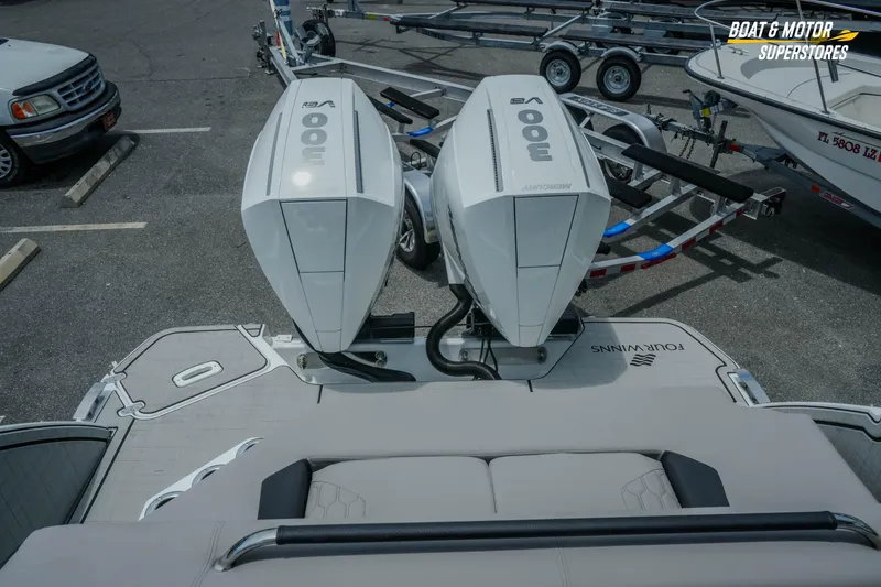 Slide: The Image of 2026 Four Winns H9 OB boat with dual Mercury 300 engines at a dealership. - 38