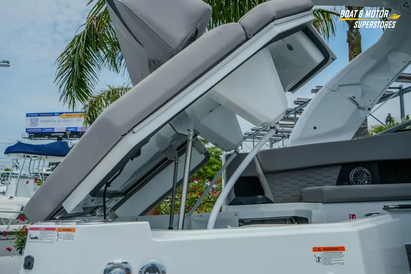 Slide: The Image of 2026 Four Winns H9 OB boat with open storage compartment, showcasing sleek design and functionality. - 5
