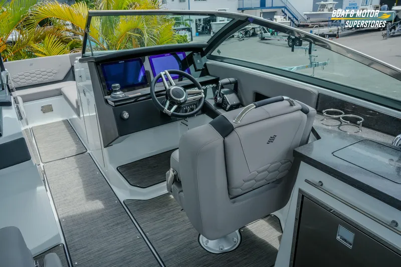 Slide: The Image of 2026 Four Winns H9 OB boat interior with modern helm, seating, and dashboard controls. - 7
