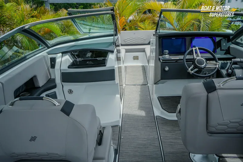 Slide: The Image of Interior of 2026 Four Winns H9 OB boat with modern dashboard and seating. - 8