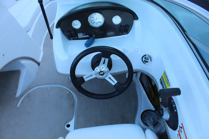 Slide: The Image of Interior view of a 2011 Four Winns H180 LE boat helm. - 10
