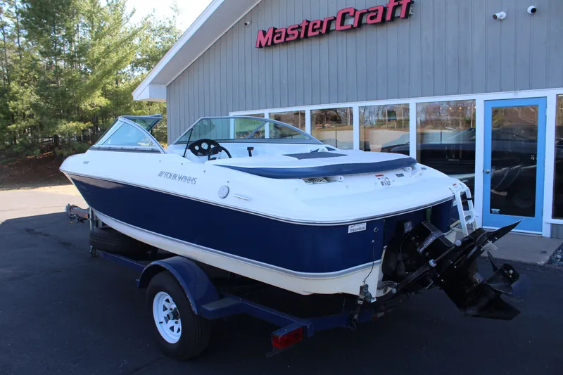 Slide: The Image of 2011 Four Winns H180 LE boat outside MasterCraft building. - 3
