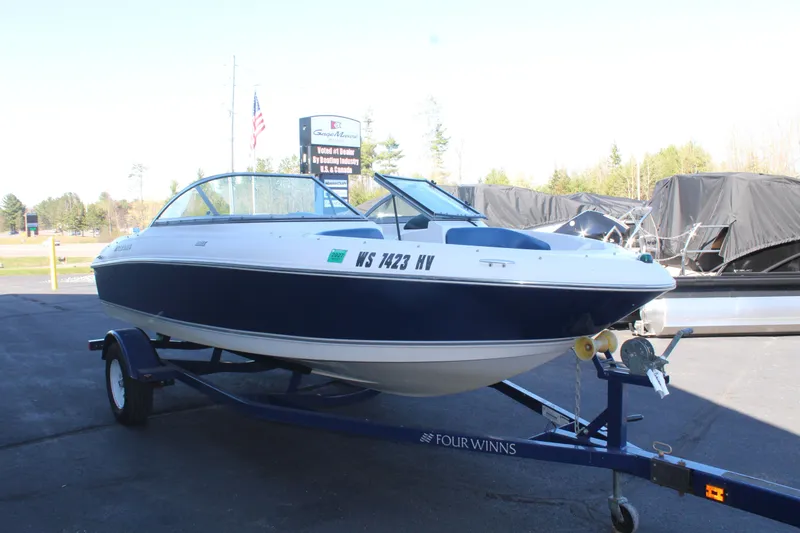 Slide: The Image of 2011 Four Winns H180 LE boat on trailer outdoors. - 5
