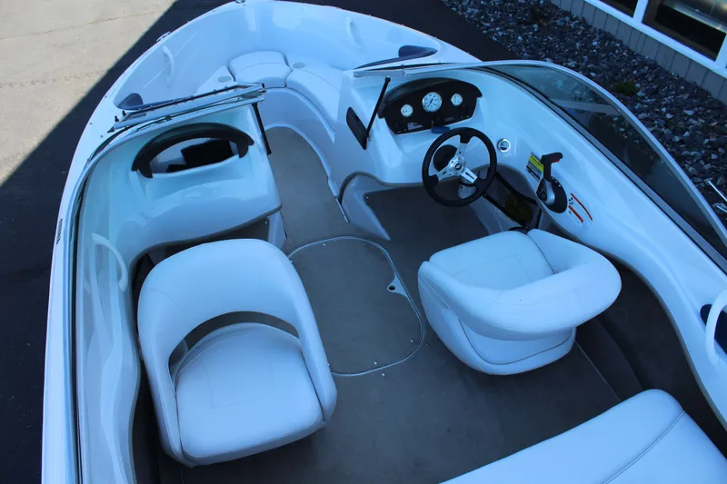Slide: The Image of Interior of a 2011 Four Winns H180 LE boat with white seating. - 7