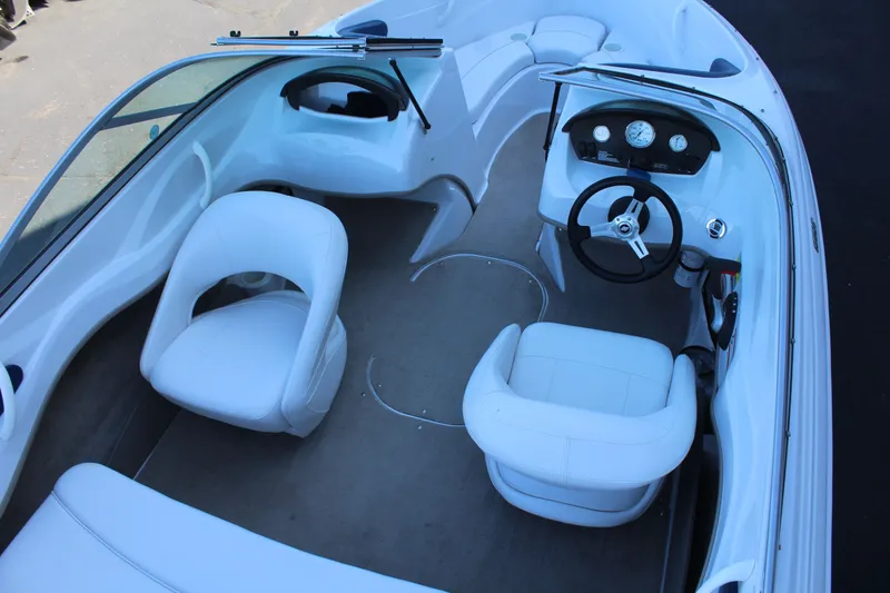 Slide: The Image of Interior of a 2011 Four Winns H180 LE boat with white seating. - 8