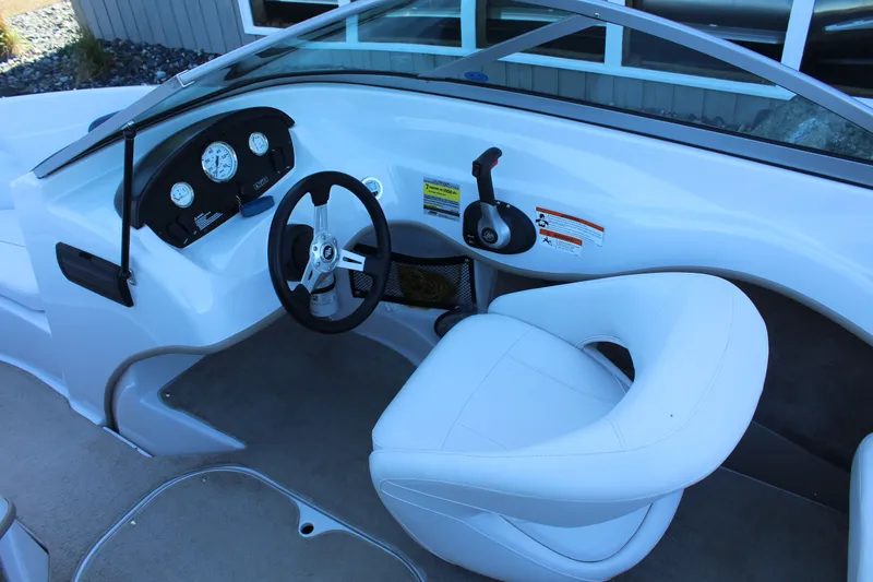 Slide: The Image of Interior of a 2011 Four Winns H180 LE boat with steering console. - 9