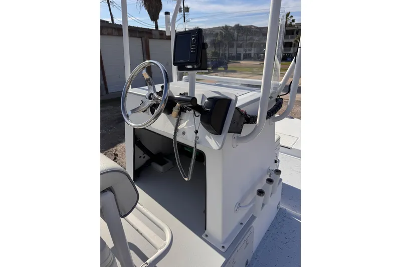 Slide: The Image of 2006 Waterman K-18 boat console with steering wheel and navigation equipment. - 10