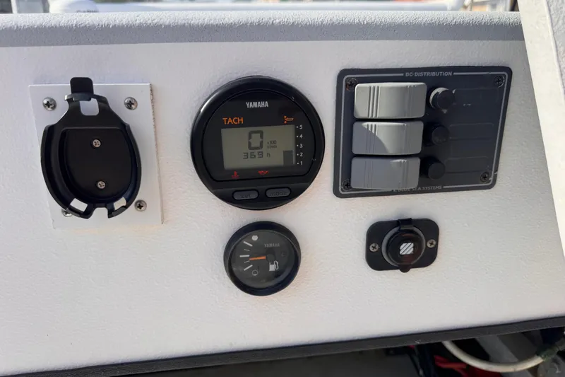 Slide: The Image of Control panel of a 2006 Waterman K-18 boat with Yamaha tachometer and switches. - 15