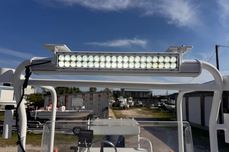 Slide: The Image of LED light bar on a 2006 Waterman K-18 boat under a clear blue sky. - 17
