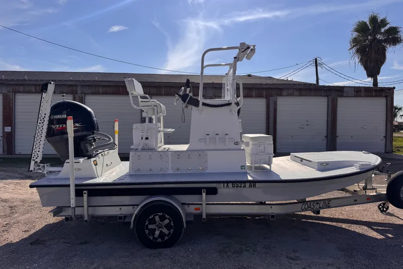 Slide: The Image of 2006 Waterman K-18 boat with Yamaha engine on trailer, parked outdoors. - 2