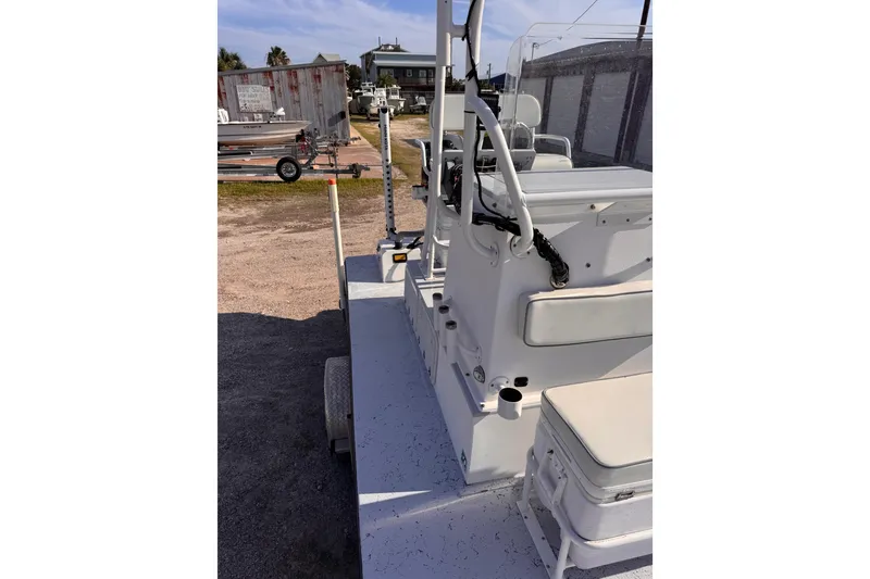 Slide: The Image of 2006 Waterman K-18 boat interior with seating and controls, parked outdoors. - 20