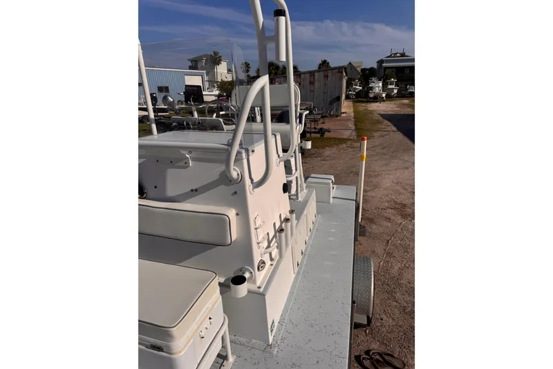 Slide: The Image of 2006 Waterman K-18 boat on trailer, parked outdoors under clear blue sky. - 22