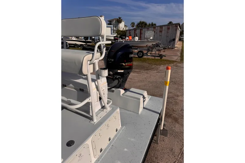 Slide: The Image of 2006 Waterman K-18 boat with Yamaha 175 engine, parked outdoors. - 26