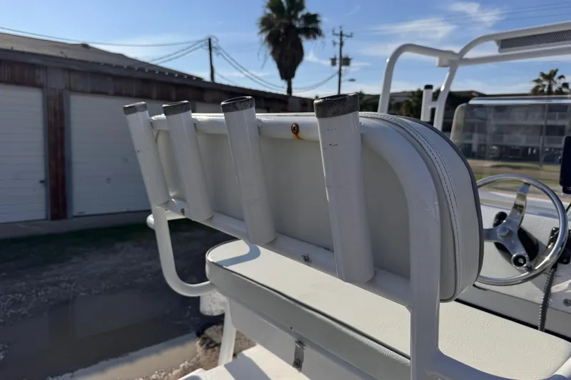 Slide: The Image of White Waterman K-18 boat seat with rod holders, 2006 model, in a sunny outdoor setting. - 30