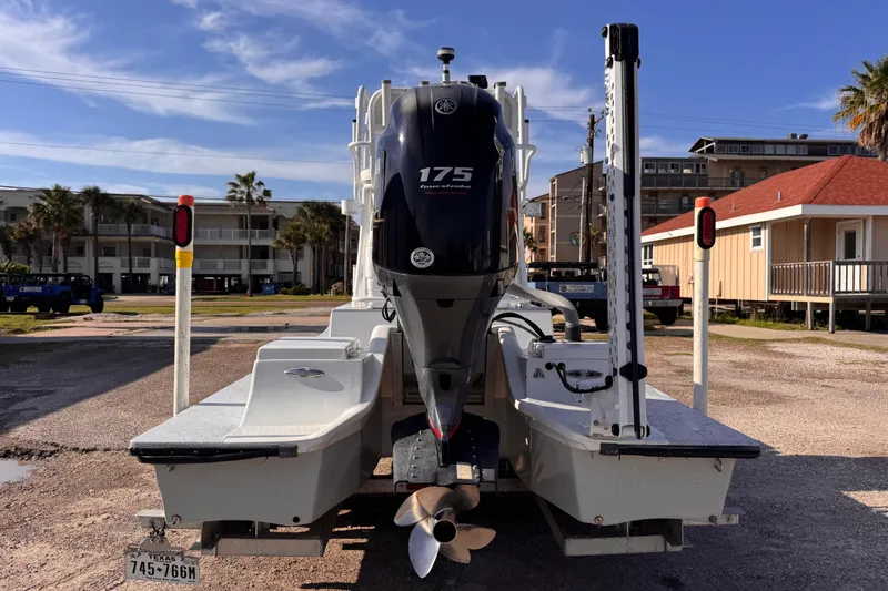 Slide: The Image of 2006 Waterman K-18 boat with 175 horsepower engine, parked outdoors on a sunny day. - 7