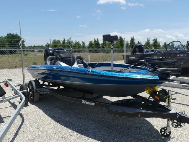 Slide: The Image of 2022 Triton 179 TrX boat on trailer outdoors. - 3