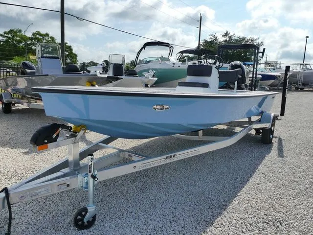 The Image of 2026 Xpress Skiff 185 boat on trailer, blue hull. - 1