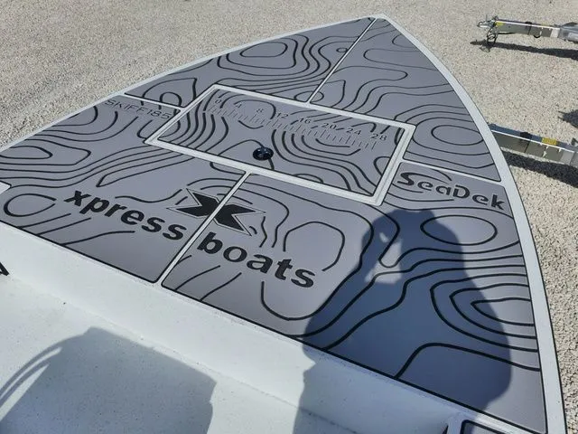 Slide: The Image of Xpress Skiff 185 boat deck with SeaDek design, model year 2026. - 12