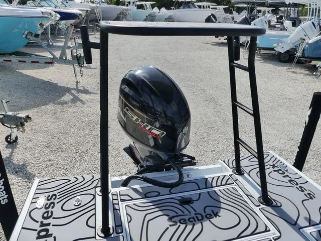 Slide: The Image of 2026 Xpress Skiff 185 boat with outboard motor and Seadek flooring. - 6