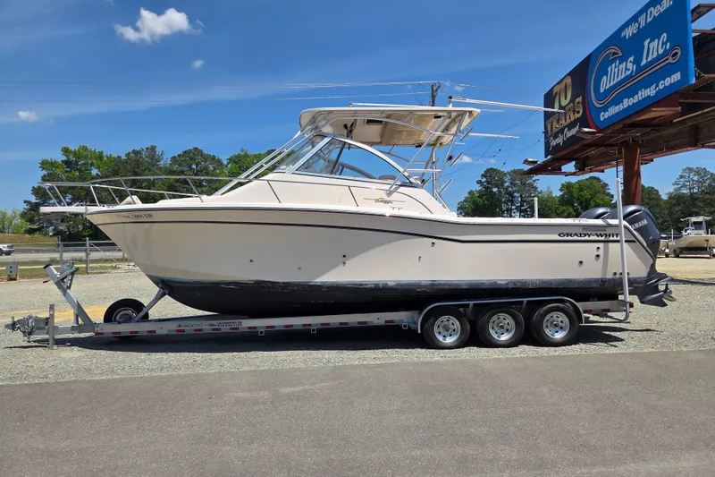 The Image of 2007 Grady-White Express 305 boat on trailer at dealership, clear sky background. - 0