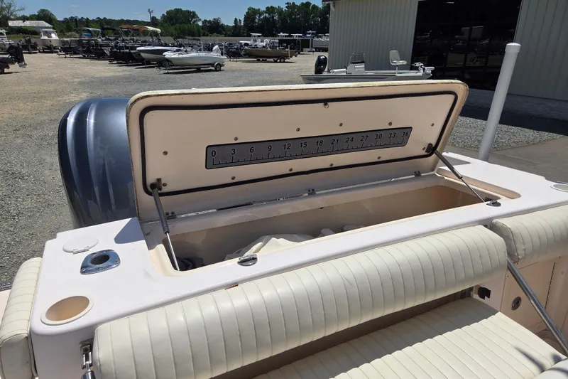 Slide: The Image of 2007 Grady-White Express 305 boat with open storage compartment and measuring scale. - 10