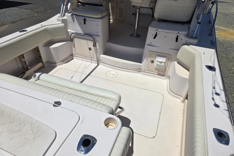 Slide: The Image of 2007 Grady-White Express 305 boat interior with cushioned seating and storage compartments. - 11