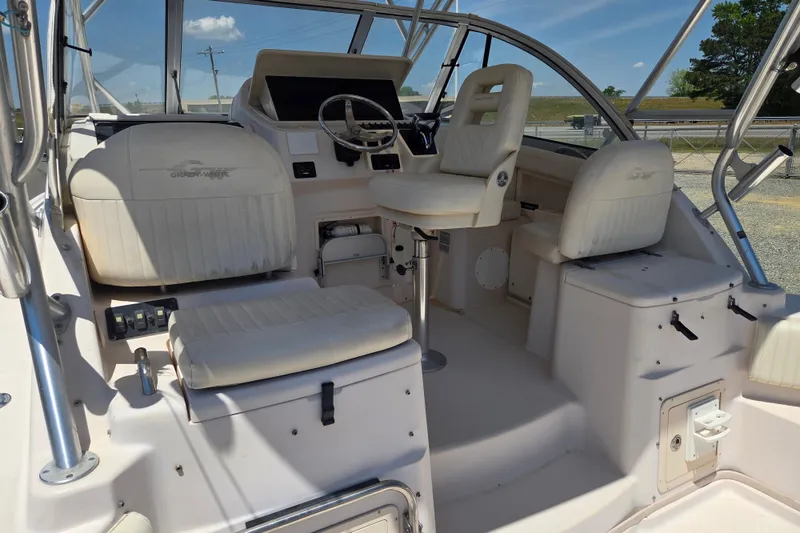 Slide: The Image of 2007 Grady-White Express 305 boat interior with helm and seating area. - 12