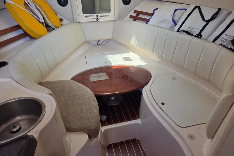 Slide: The Image of 2007 Grady-White Express 305 cabin interior with seating, table, and life jackets. - 16