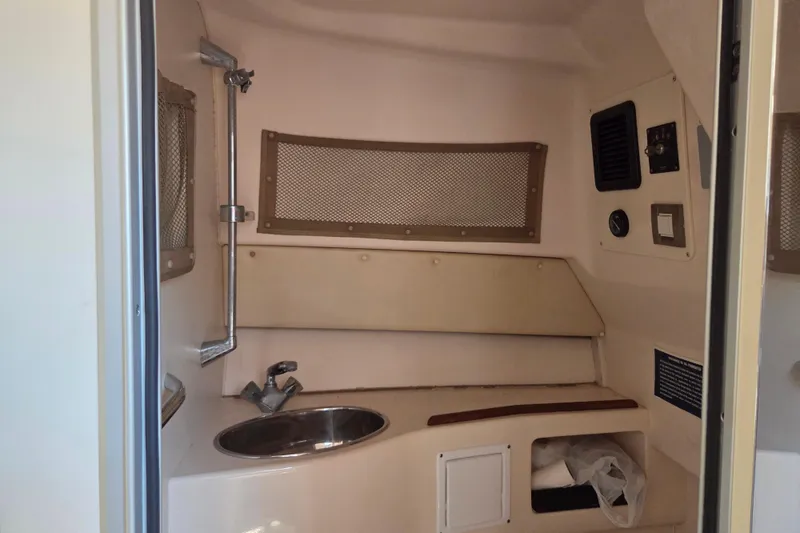 Slide: The Image of 2007 Grady-White Express 305 boat interior with sink and storage compartments. - 18