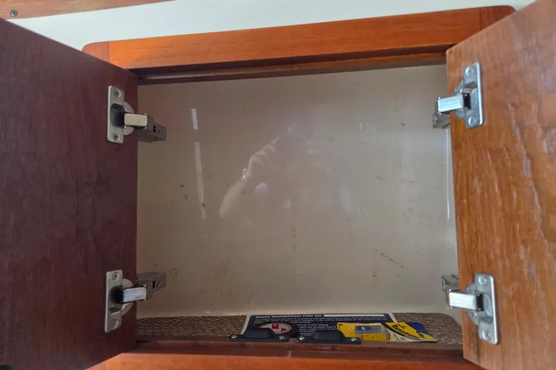 Slide: The Image of Open wooden cabinet on 2007 Grady-White Express 305 boat interior. - 21