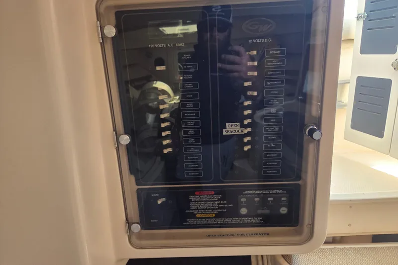 Slide: The Image of Electrical panel of a 2007 Grady-White Express 305 boat, showing AC and DC switches. - 24