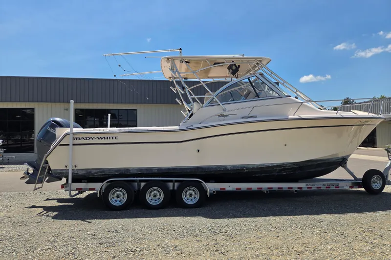 Slide: The Image of 2007 Grady-White Express 305 boat on trailer, parked outdoors under clear sky. - 6