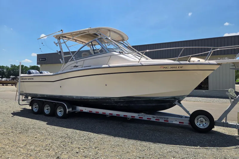 Slide: The Image of 2007 Grady-White Express 305 boat on trailer, parked outdoors under clear sky. - 7