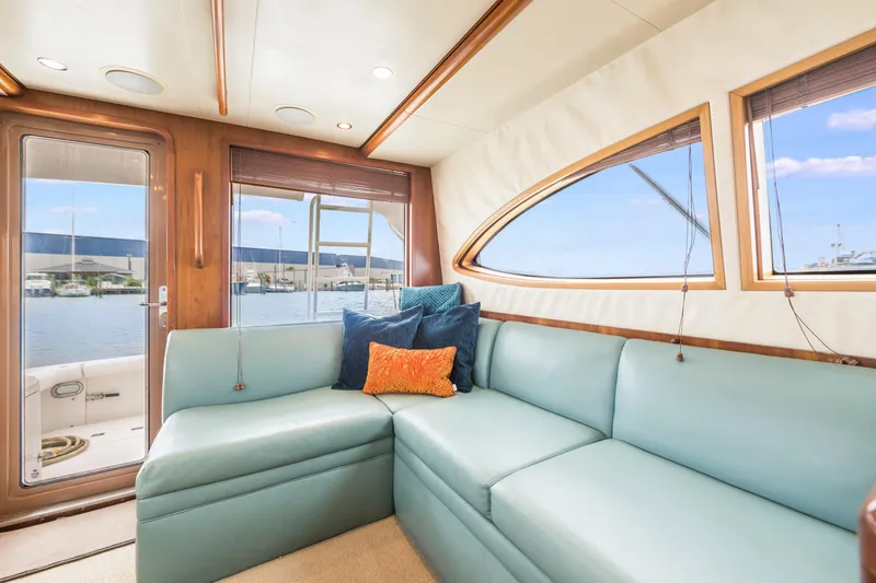 Slide: The Image of Luxurious interior of 2004 Bertram 390 Convertible yacht with plush seating and scenic windows. - 14