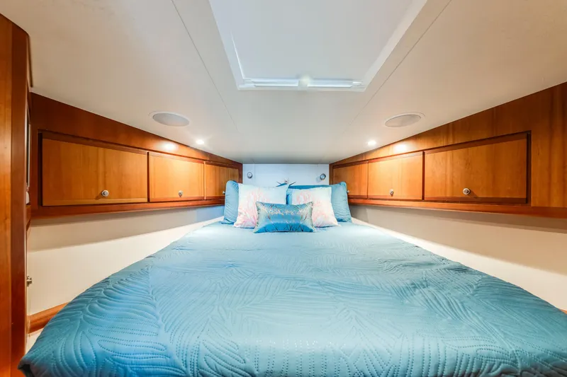 Slide: The Image of Luxurious cabin interior of 2004 Bertram 390 Convertible yacht with cozy bedding. - 18