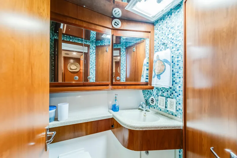 Slide: The Image of Luxurious bathroom in 2004 Bertram 390 Convertible yacht with mosaic tiles and wooden cabinetry. - 22