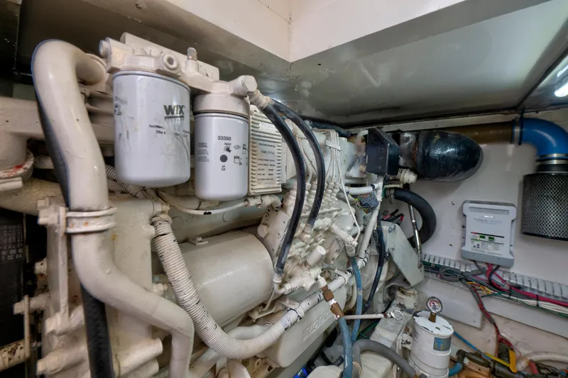 Slide: The Image of Engine room of a 2004 Bertram 390 Convertible with visible filters and wiring. - 27