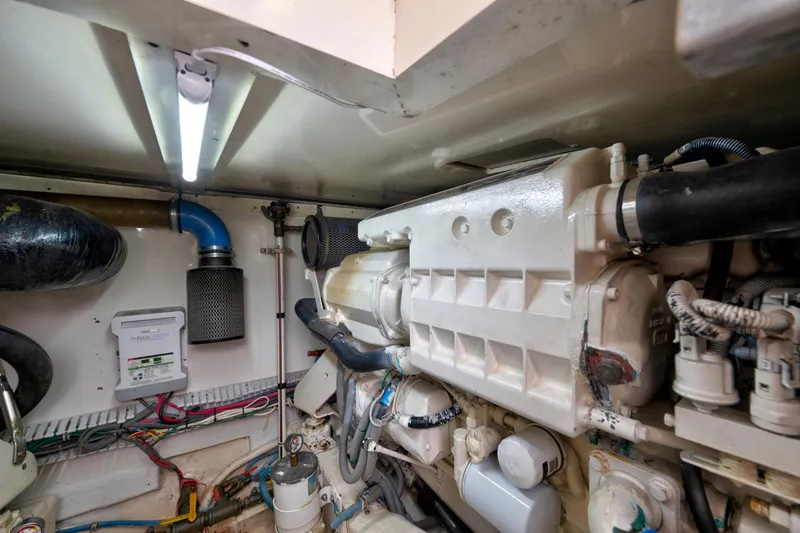 Slide: The Image of Engine room of a 2004 Bertram 390 Convertible boat, showcasing mechanical components. - 28