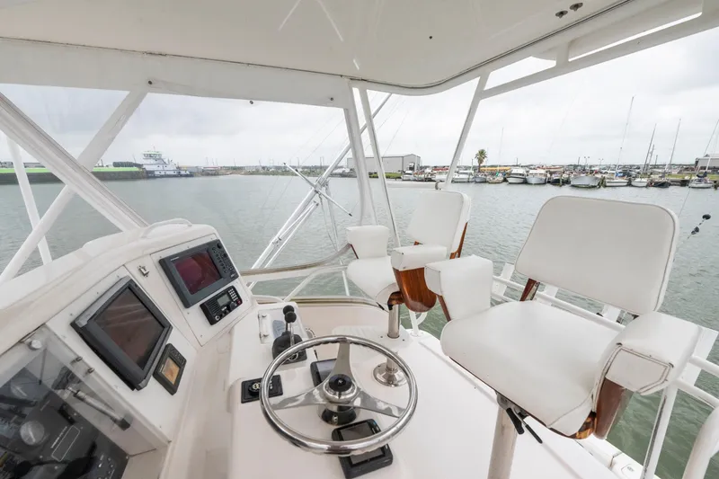 Slide: The Image of Helm of 2004 Bertram 390 Convertible yacht with steering wheel and navigation equipment. - 3