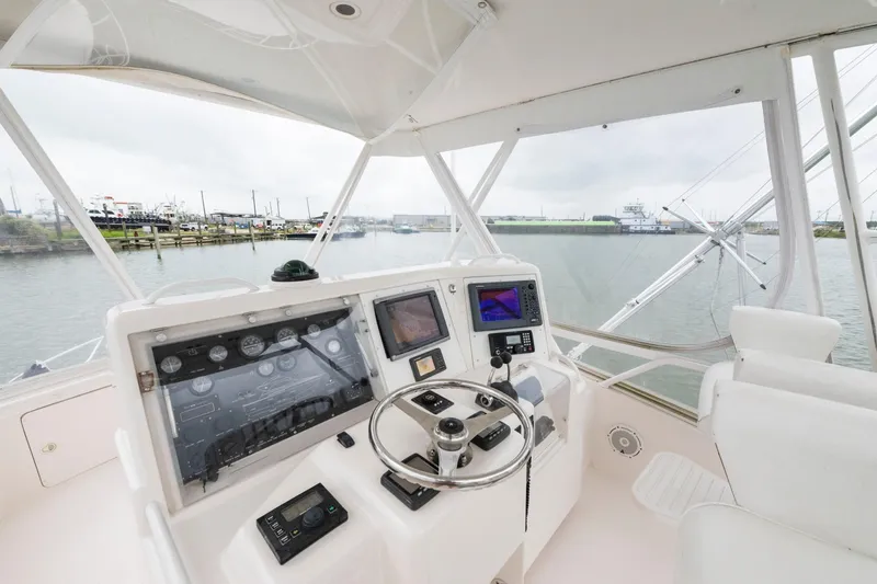 Slide: The Image of 2004 Bertram 390 Convertible yacht helm with navigation equipment and waterfront view. - 5