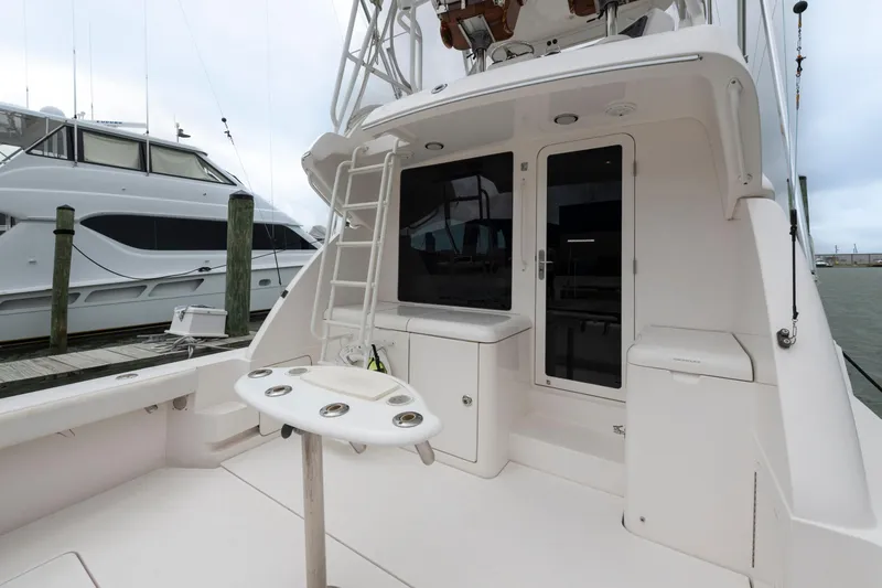 Slide: The Image of 2004 Bertram 390 Convertible yacht deck with fishing station and ladder, docked at marina. - 8