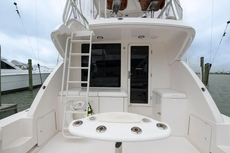 Slide: The Image of 2004 Bertram 390 Convertible yacht stern view with ladder and fishing rod holders. - 9