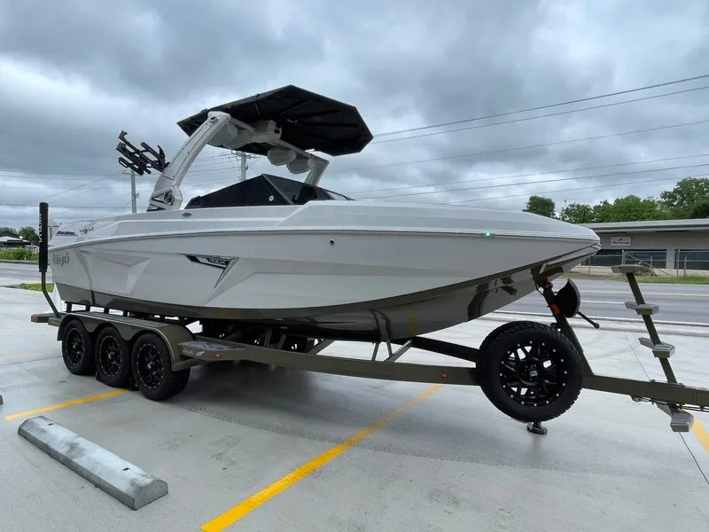 Slide: The Image of 2024 Tigé 24RZX boat on trailer, gray sky. - 11